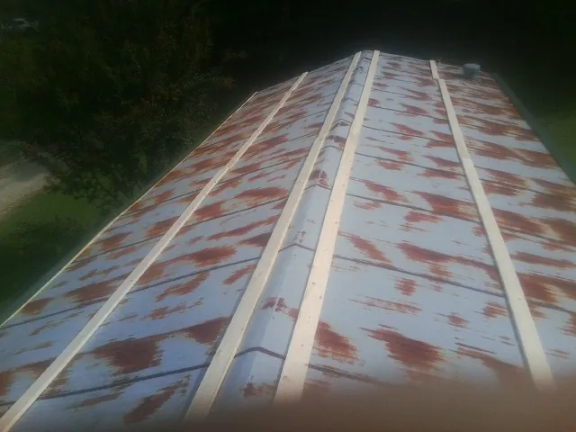 Rusted metal roof panels with new wood purlins before replacement — Storm Damage Roof Repair in Dahlonega by Roofing Brothers