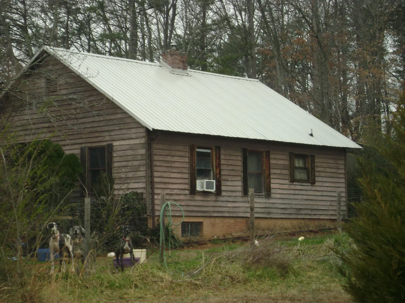 White metal roof on an old wood sided farmhouse, from a Metal Roof Installation job in Dahlonega